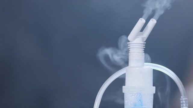 Compression inhaler sprays medicinal mixture through nasal nozzle. Treatment of lung diseases asthma pneumonia bronchitis and allergic problems. spraying of medicine through inhaler. Copy space.