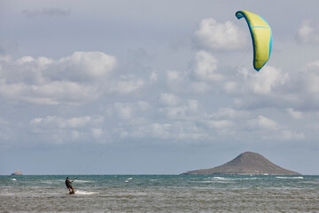 Mature man practicing kitesurfing. Aquatic sport. Athletic healthy senior