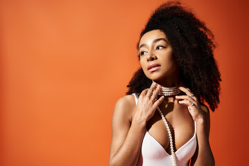 Stunning young African American woman in stylish swimwear against a vibrant backdrop