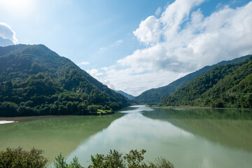 Lake among green sunny mountains