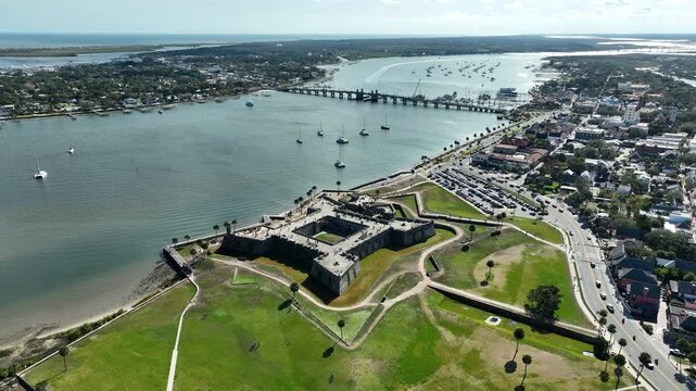 A sweeping drone view above Castillo de San Marcos showcases the historic fort overlooking Matanzas Bay and downtown St. Augustine.