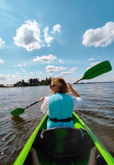 young woman kayaking on the river, summer activities 