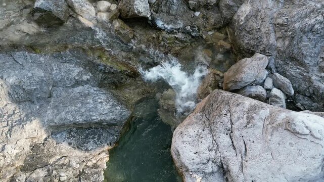 Aerial drone footage over the Susaibes stream near Andreis, Italy: clear water, rocky bed and pristine alpine surroundings. Ideal for nature, travel and scenic stock footage.