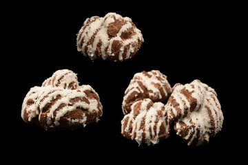Profiteroles with coconut cream on a black background.
