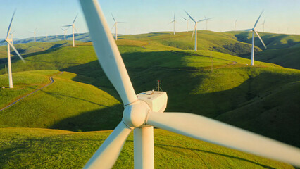 Close-up of Wind Turbine in Grassy Rolling Hills at Sunset © @ArtUmbre