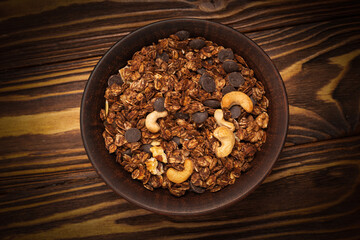 Chocolate granola cereal with nuts in a bowl.