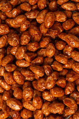 Tasty sweet roasted peanuts as a background.