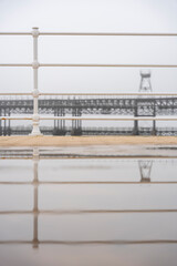 Fototapeta premium Huelva. Photo of the Tinto Wharf from the riverfront promenade. Very foggy winter day.