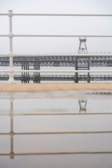 Fototapeta premium Huelva. Photo of the Tinto Wharf from the riverfront promenade. Very foggy winter day.