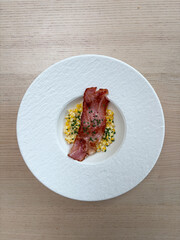 A plate of creamed corn and bacon.