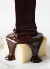 Chocolate Ganache Dripping Over Soft Sponge Cake Slice for Dessert Stock Photo