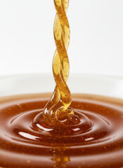 Closeup Of Rich Caramel Sauce Drizzle Swirling Into Golden Dessert Syrup