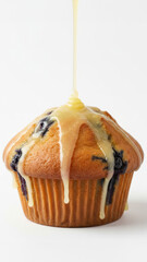 Golden Blueberry Muffin With Lemon Glaze Dripping Over Top, Fresh Blueberries Inside