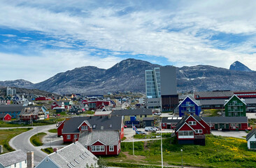 Colorful houses in Nuuk city, Greenland with mountains and modern buildings in background © benny