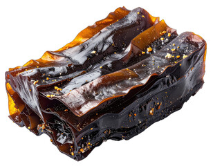 A close-up photograph of a stack of dark, glossy kelp sheets dusted with fine golden particles against a black background.