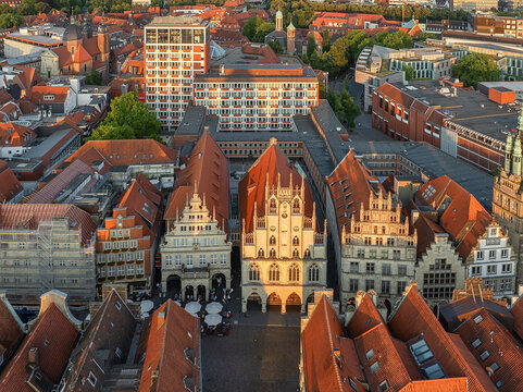 Aerial view of the Prinzipalmarkt's gabled facades gleam under the summer sun, a harmonious blend of history and modern life, Munster, North Rhine-Westphalia, Germany.