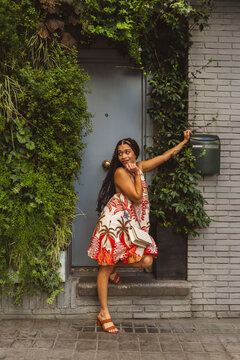 Woman posing on front stoop