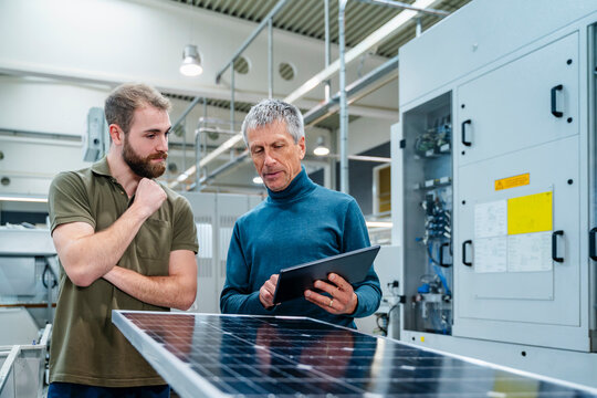 Businessman guiding colleague at industry