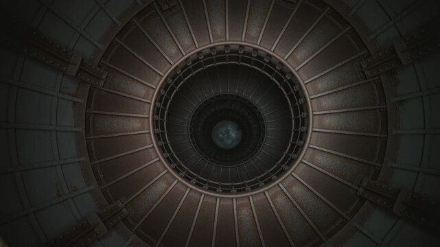View looking down a spiral staircase with rusted metal and circular patterns. Abstract industrial design with repeating elements.
