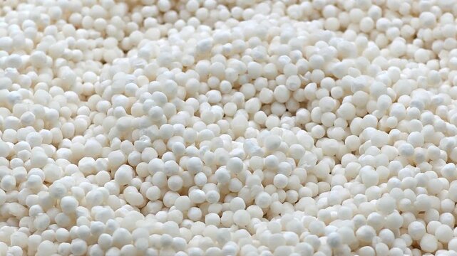 Slow motion macro of dry white tapioca pearls for authentic boba tea concept