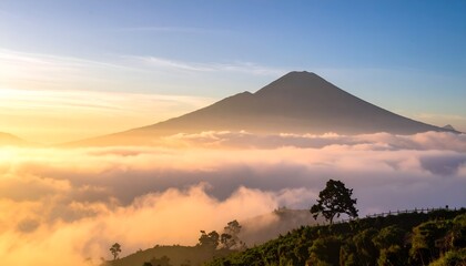 Obraz premium Majestic Mountain Peak Emerging from a Sea of Clouds at Sunrise.