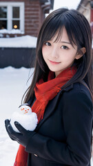 雪景色の中で雪だるまを持つ笑顔の若い女性