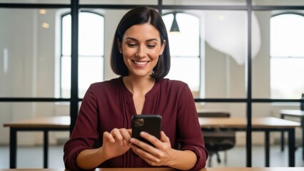 Naklejka premium Woman using smartphone in modern office