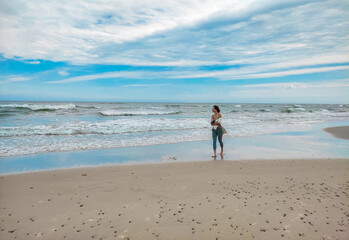young woman walking on the beach