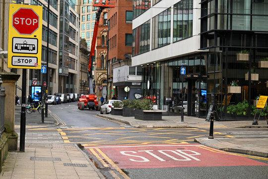 Dangerous tram crossing on Mosley Street in Manchestet city centre. High conspicuity STOP markings and road signs placed to make drivers aware.