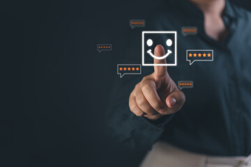 Fototapeta premium Customer satisfaction and feedback concept. Hand touching smiley face icon with five star rating, symbolizing positive experience, service quality, user review, and digital evaluation
