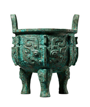 Ancient Chinese bronze Ding vessel with green patina and Taotie motifs. Ritual tripod.