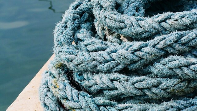 Blue rustic rope for the boat by the sea in harbour , nautical background
