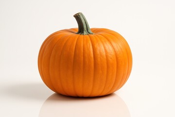 Obraz premium A bright orange pumpkin with vertical grooves and a pronounced stem is depicted on a white background, embodying autumn and naturalness.