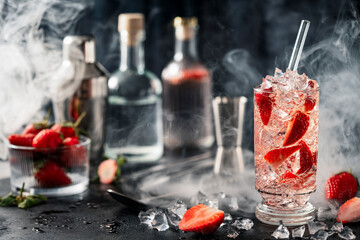 Summer Strawberry Cocktail with Crushed Ice and Fresh Strawberries on Dark Bar Background