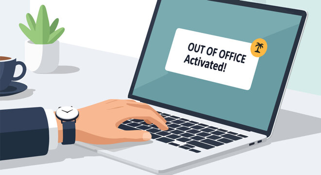 Businessman's hand typing on laptop with 'Out of Office Activated!' notification on screen, modern office desk setting