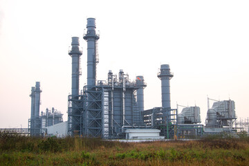 Natural Gas Combined Cycle Power Plant with sunset and light orange