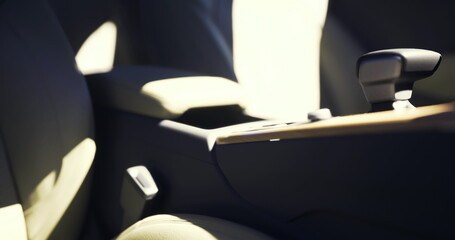 Fototapeta premium sunlit beige car interior close up revealing leather upholstery, center console and seatbelt buckle bathed in warm morning glow soft shadows emphasize texture