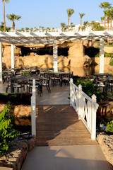 A beautiful wooden staircase an outdoor restaurant.