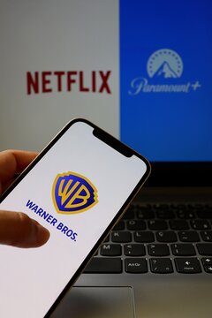 Salvador, Brazil - January 21, 2026: Warner Bros. logo on smartphone screen with Netflix and Paramount logos in the background. Netflix, Paramount and Warner Bros brands.