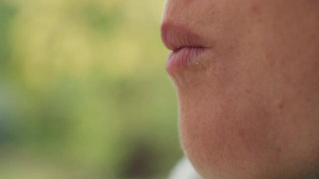 caucasian woman closeup mouth profile reflecting after taste, subtle pucker and chew, sensory focus on lips and chin, soft bokeh garden background, calm contemplative mood and slow living rhythm