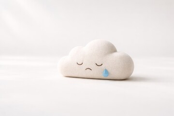 A soft, plush cloud with a sad expression and a single blue tear, symbolizing sorrow and melancholy.