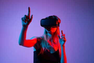 Woman using hand tracking in VR gaming, interacting with virtual world using gestures, neon red blue light background