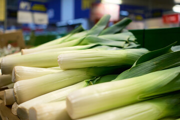 Fresh leeks displayed in a market stall for shoppers to purchase and enjoy in various dishes