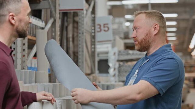Mature men standing gin front of each other and communicating about new collection of wallpaper