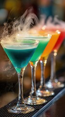 Colorful smoke-infused cocktails lined up on bar counter