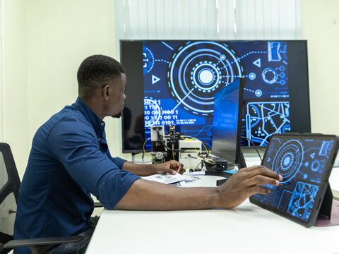 Black Researcher Making a Quantum Computing Experiment, Monitoring Live Artificial Intelligence Data on Computer Screen,