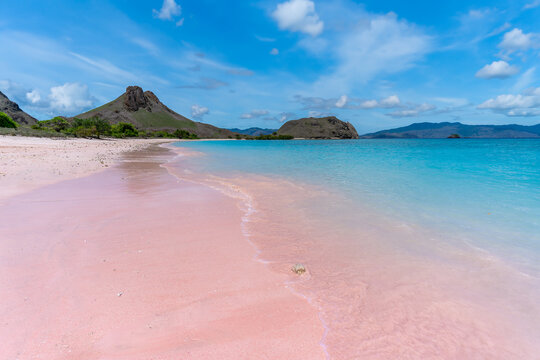 Pink beach on Komodo Island where soft blush sands blend with turquoise waters under a vivid sky in Indonesia&rsquo;s paradise.