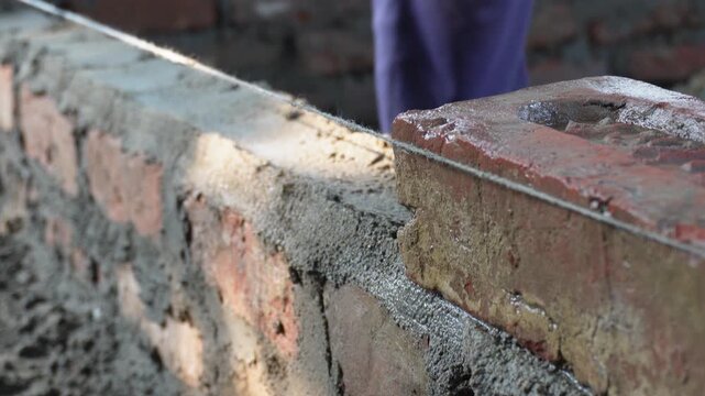 Bricklaying involves skilled workers constructing walls with bricks and mortar