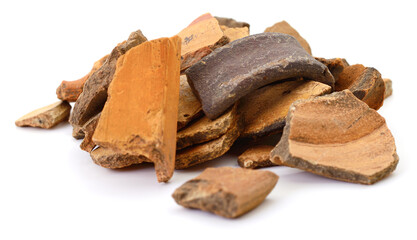 Pile of ancient clay pottery shards isolated on white background