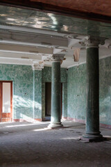 Fototapeta premium Empty room with classical columns in abandoned sanatorium, Tskaltubo, Georgia